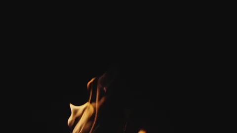 Slow motion campfire flames burst and dance with logs in fire pit Video stock 128779731