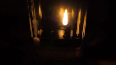 Slow motion of a candle burning in the dark Stock Footage