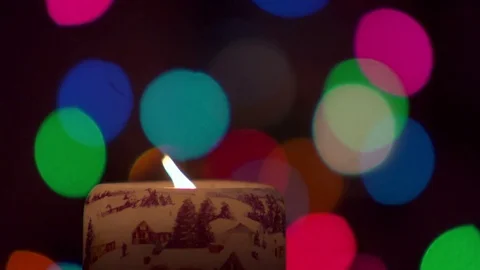 Slow motion candle flame against Christmas light Bokeh. Stock Footage 84771840