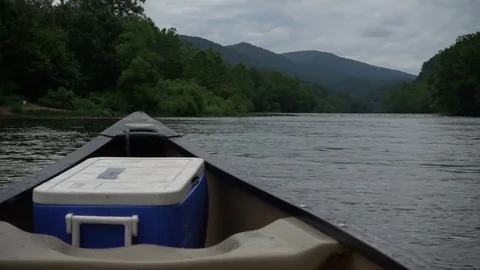 SLOW MOTION CANOE ON MOUNTAINOUS RIVER FLOAT TRIP Stock Footage 84292147