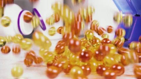 Slow motion capsules and tablets fall on the table Stock Footage 93745307