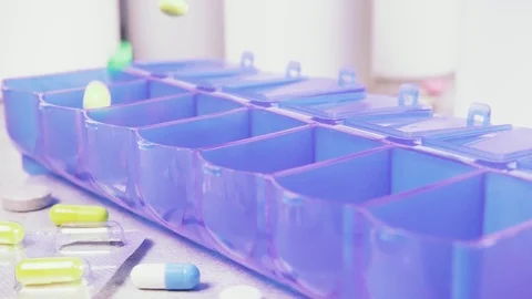 Slow motion capsules and tablets fall on the table Stock Footage 93745550