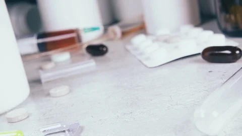 Slow motion capsules and tablets fall on the table Stock Footage 93746046