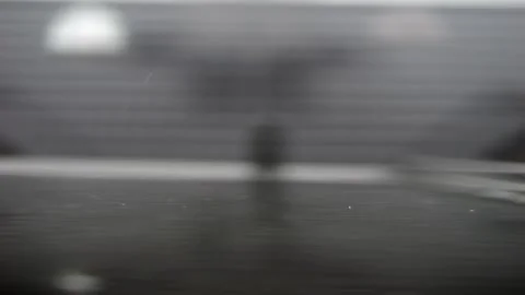 Slow-motion capture of raindrops hitting an open skylight. The droplets bre.. Stock Footage 286054420