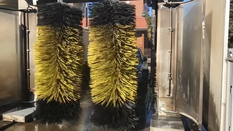 Slow motion of car being washed by brushes inside a car wash Stock Footage 102448101
