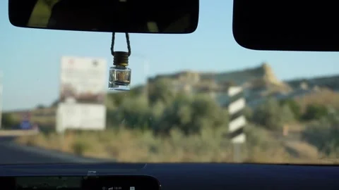Slow motion of a car deodorizer in a moving car on the streets of cappadocia Stock Footage 263174568