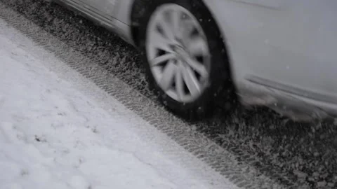 Slow Motion of a Car Driving on a Snow-Covered Road During Winter Conditions Stock Footage 341960979