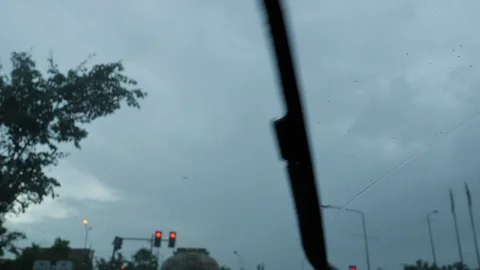 Slow motion, car driving through red traffic light in rainy day Stock Footage 113895214