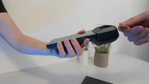 Slow motion card payment on POS terminal during retail checkout process Stock Footage 325961996