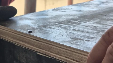 Slow Motion Carpenter Driving Nail into Wood Stock Footage 336430337