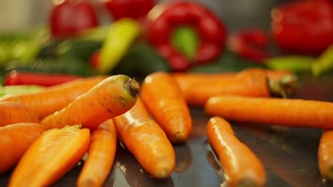 Slow motion of a carrot twisting around itself among other vegetables. Stock-Footage 296361966