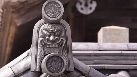 Slow motion of carved guardian statue on Japanese temple rooftop Stock Footage 331129340