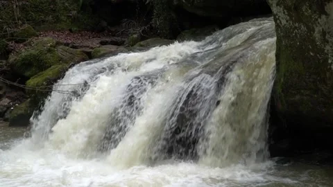 Slow motion of cascade inside forest the three waterfalls at Schiessentuempel Stock Footage