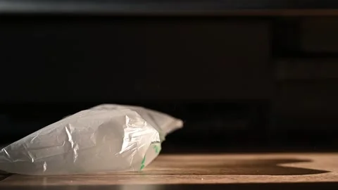 Slow motion of a Caucasian boy jumping on plastic bubble wrap packaging pillow. Video stock 226828026