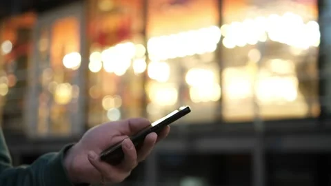 Slow motion Caucasian man looking at mobile phone on the street by the office Stock Footage 166886737