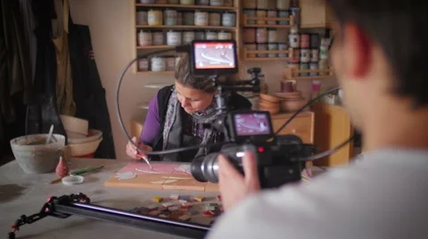 Slow motion of ceramic maker working in front of a video-maker Stock Footage 61952178