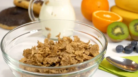 Slow motion of cereals flakes falling in bowl for breakfast Stock Footage 85357519