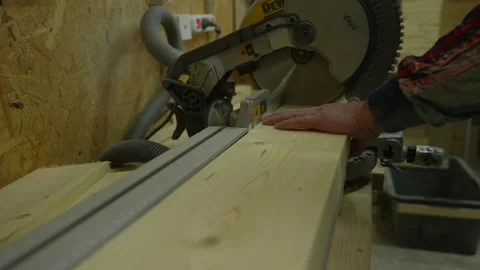 Slow motion of chainsaw cutting a log in slow motion with saw dust flying in the Stock Footage 202000007