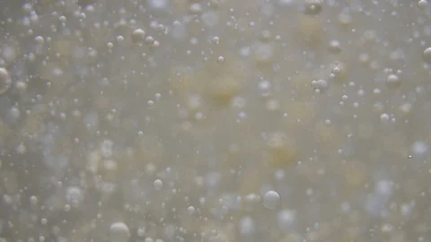 Slow motion chaotic motion drops one liquid into another Stock Footage 129845619