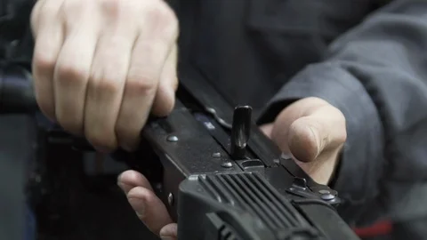 Slow motion charging rifle. Unlocking assault rifle. AK47 loading. Factory Stock Footage 129725670