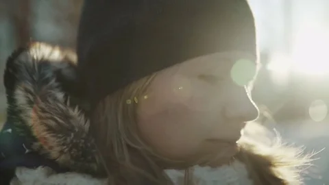 Slow-motion of a charming winter lady blowing a handful of snow right in the Stock-Footage 83438750