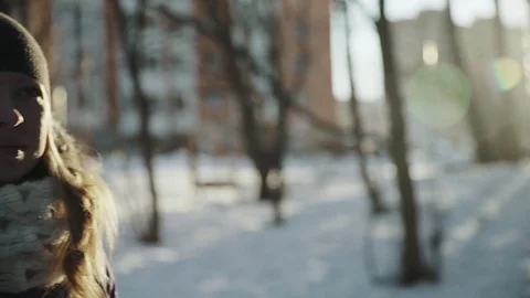 Slow-motion of a charming winter lady blowing a handful of snow right in the Video stock 83438995