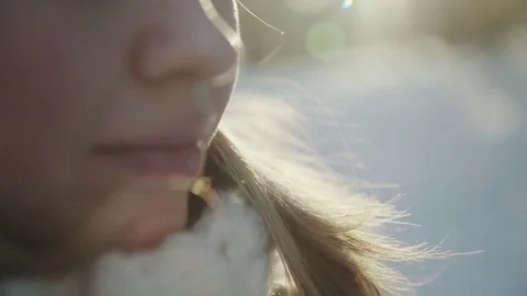 Slow-motion of a charming winter lady blowing a handful of snow right in the Stock-Footage 83439253