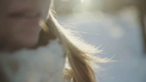 Slow-motion of a charming winter lady blowing a handful of snow right in the Stock-Footage 83439506