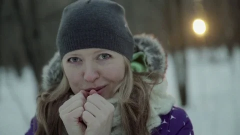 Slow-motion of a charming winter lady blowing a handful of snow right in the Stock-Footage 83448427