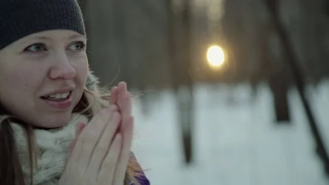 Slow-motion of a charming winter lady blowing a handful of snow right in the Stock-Footage 83448727