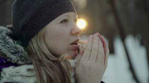 Slow-motion of a charming winter lady blowing a handful of snow right in the Stock-Footage 83449106