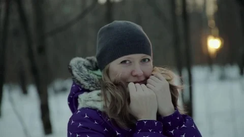 Slow-motion of a charming winter lady blowing a handful of snow right in the Stock-Footage 83449577