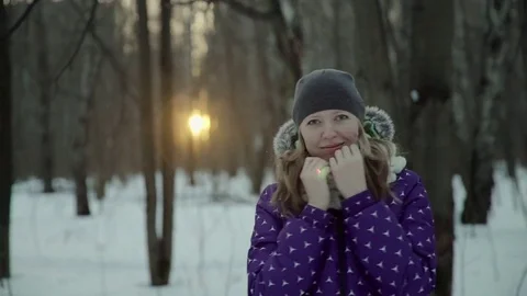 Slow-motion of a charming winter lady blowing a handful of snow right in the Stock-Footage 83449907