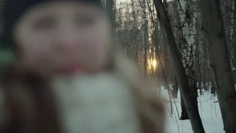 Slow-motion of a charming winter lady blowing a handful of snow right in the Stock-Footage 83450215