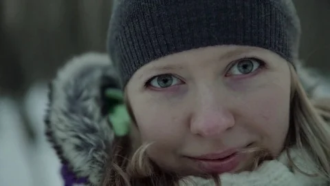 Slow-motion of a charming winter lady blowing a handful of snow right in the Stock-Footage 83450569