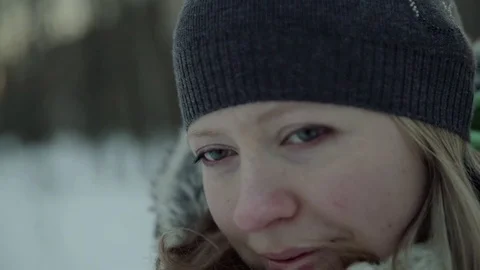 Slow-motion of a charming winter lady blowing a handful of snow right in the Stock-Footage 83451024