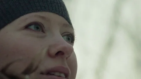 Slow-motion of a charming winter lady blowing a handful of snow right in the Stock-Footage 83456812
