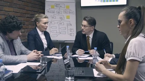 Slow motion. Cheerful boss talking with colleagues Stock Footage 73780183