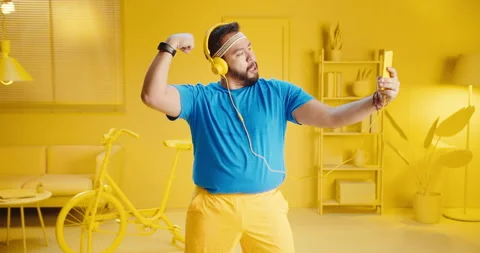 Slow motion of cheerful overweight bearded man in blue t-shirt taking selfie Stock Footage 165865943
