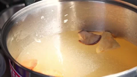 Slow motion of chef adding carrot to Homemade Sukiyaki or Shabu boiling in pot  Stock-Footage 159004255