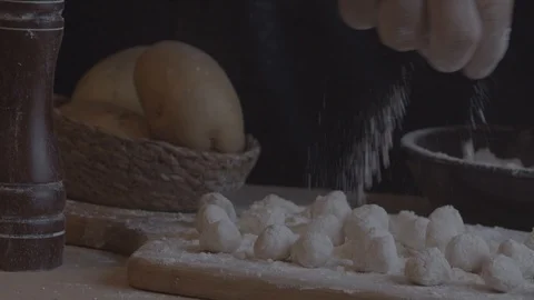 Slow motion of a chef adding the flour to the gnocch Stock Footage 128288568