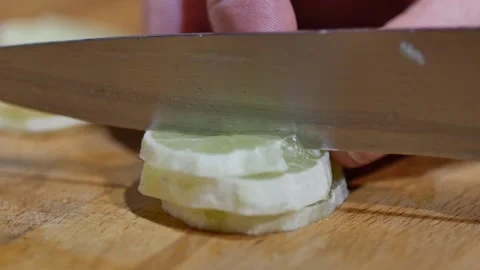 Slow motion of Chef cutting green lime in pieces with knife on wood cutting Stock-Footage 143794062