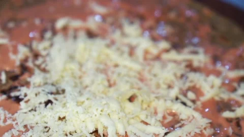 Slow motion chef grating parmesan cheese to make a delicious tortilla Stock Footage 230080463