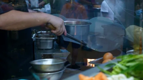 Slow Motion of Chef Hands Frying Rice in Big Pan on Fire on Asian Food Court Stock Footage 125065824