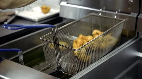 Slow Motion Chef picking out done Zepoli from Fryer Williamsburg Brooklyn Stock Footage 252330746
