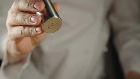 SLOW MOTION: Chef Pouring Salt From The Salt Shaker While Cooking Stock Footage