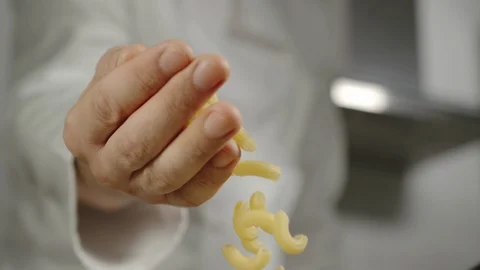 SLOW MOTION: Chef Pours Macaroni While Cooking Stock Footage 113990805