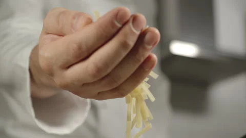 SLOW MOTION: Chef Pours Small Fettuccine Pasta While Cooking Stock Footage 160331501