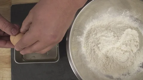 Slow motion Chef Separating the Eggs and adding it to flour Stock Footage 85879261