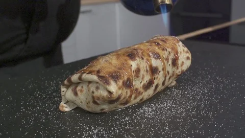 Slow motion Chef sprinkling Sugar on a Crepe Stock-Footage 85854427